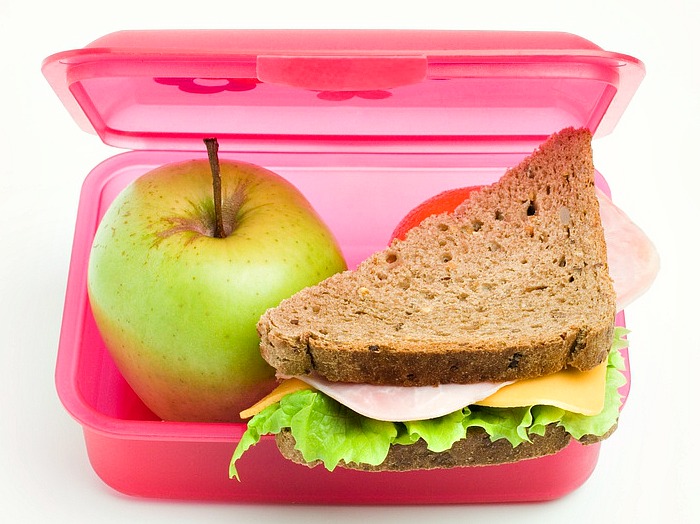 lunch box with sandwich and apple